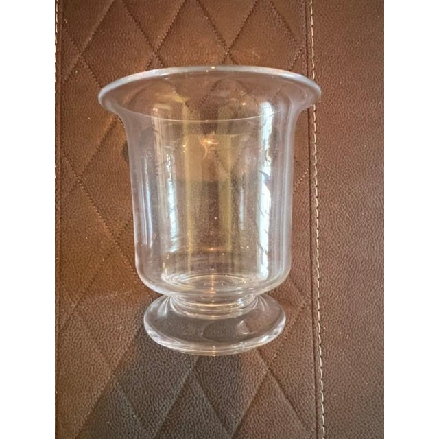 This piece is glassware or a vase manufactured by the Simon Pearce Company. The iconic, hand-etched signature found on the...