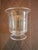 This piece is glassware or a vase manufactured by the Simon Pearce Company. The iconic, hand-etched signature found on the...