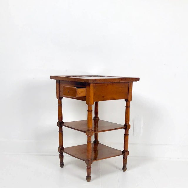 A late 18th-century French Louis XVI–period walnut and marble wine table, circa 1780, with two copper bottle holders inset...