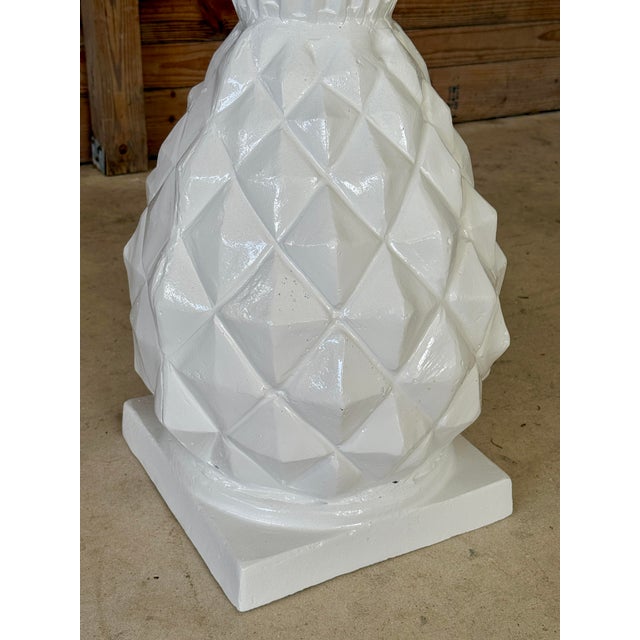 Striking pair of large cast metal pineapple planters featuring a faceted, sculptural body and flared crown form. Heavy and...