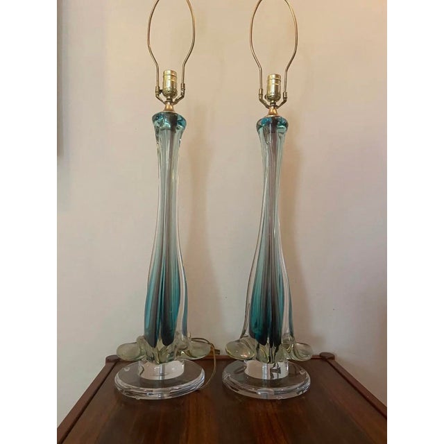 Stunning, authentic pair of Mid-Century Modern Italian Murano glass table lamps. Masterfully crafted using the traditional...