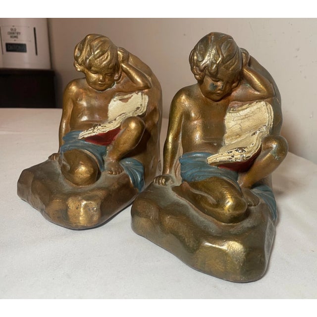 Figurative Large Pair Antique Armor Patinated Bronze Clad Co. Cherub Boy Reading Bookends For Sale - Image 3 of 12