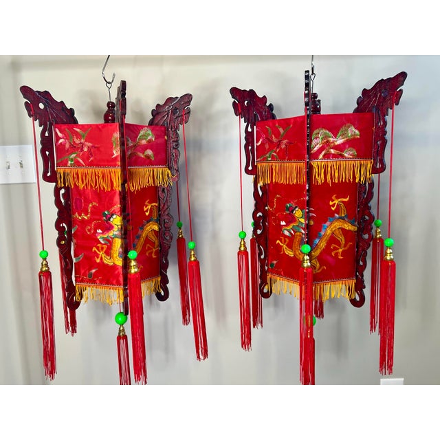 Pair of vintage Mid 20th Century Chinese palace lanterns with embroidered dragons and flowers on red satin fabric....
