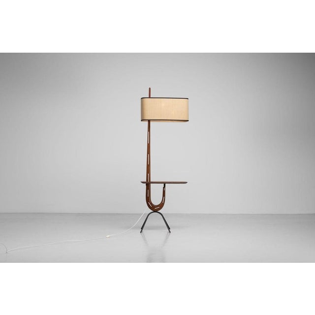 The “giraffe tablet” floor lamp, designed and produced by rispal in france circa 1950, stands as a sculptural and highly...