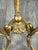 An elegant gilt bronze ashtray on a tripod base, finely decorated with foliate motifs and scrolls. The upper section...