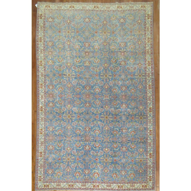 an early 20th Century Persian Tarbiz l room size rug with a blue ground Measures: 8' x 12'5''