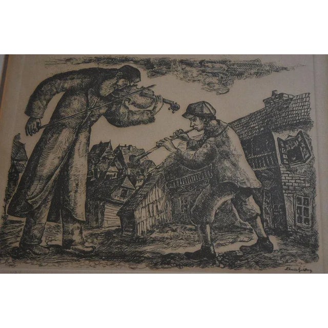 Lovely etching by artist Chaim Goldberg, depicting an old man playing violin while a young boy accompanies him on some...