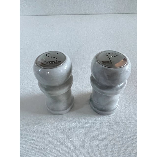 Elegantly polished carved white marble. Heavy salt and pepper set inspired by French kitchens. Each shaker is monogrammed...