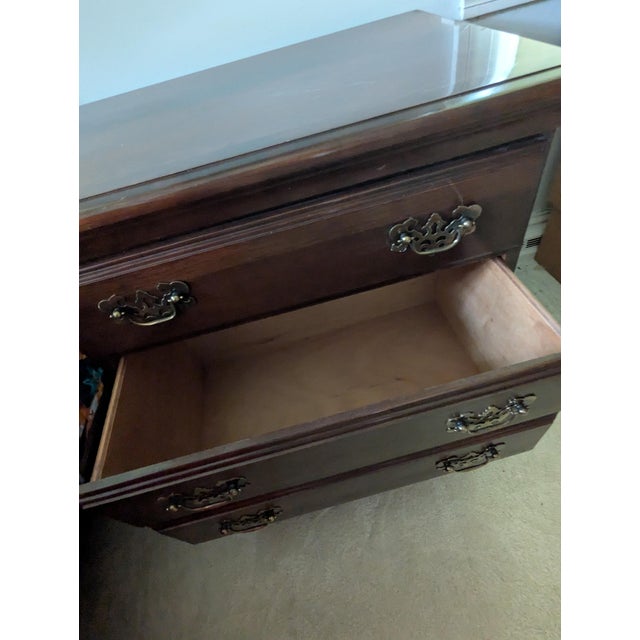Chippendale style nightstand. This item has two drawers, one smaller and the other larger. Designed to look like three...