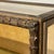 A 1940s display cabinet with a carved and gilded wooden frame, featuring a ribbed design reminiscent of Renaissance or...