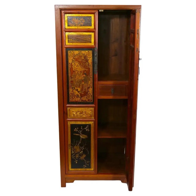Mid-20th century hand painted red / gilt lacquered wood chinoiserie display cabinet. The cabinet features two front door...