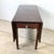 Few furniture forms capture the spirit of early American domestic life as completely as the drop-leaf table, and this...