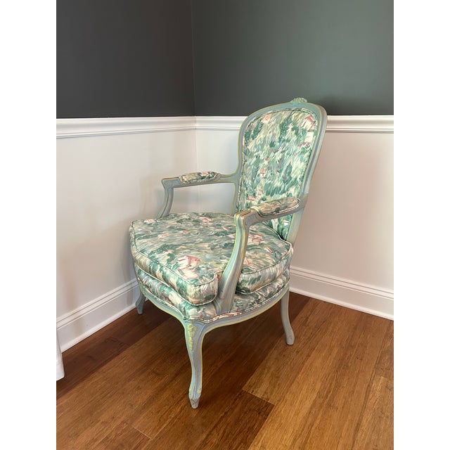 Louis XV Style French Bergere Chair. Reupholstered in beautiful floral pattern with matches the antique painted tone of...