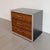 A mid-century modern black lacquered nightstand or side table with chrome details and rosewood drawer fronts. Unlabeled...