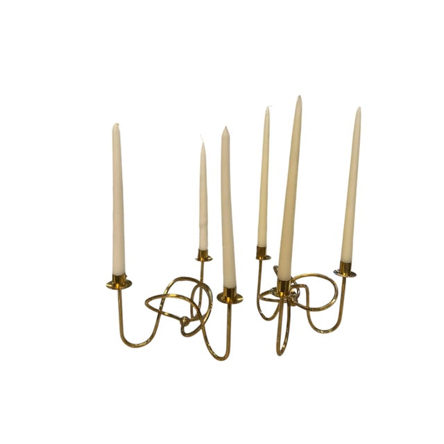 Elevate your space with this exquisite pair of Italian three-arm candelabras. Each piece features a sculptural, looped...