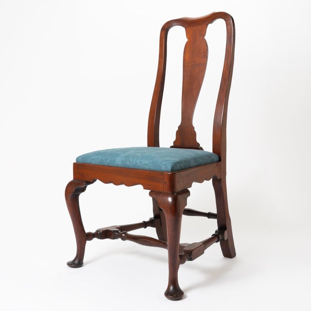 A Boston Queen Anne side chair, built in old-growth mahogany with a scalloped seat rail and cabriole legs ending in pad...