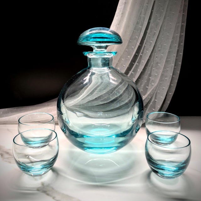 Gorgeous aquamarine decanter with 4 glasses by Czech maker, Moser, in the Culbuto pattern, designed in 1935 by Rudolf...