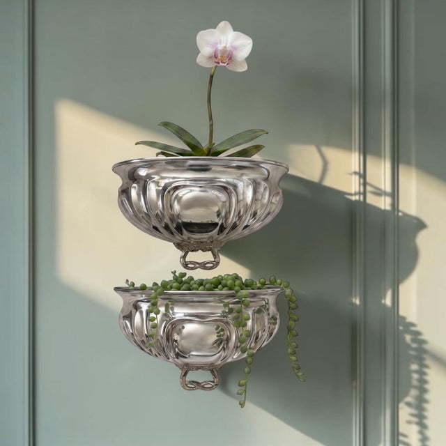 An exceptional pair of vintage silverplate meat domes thoughtfully reimagined as sculptural wall pockets, offering a...