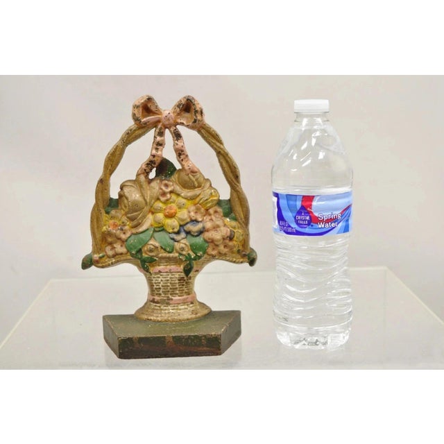 Antique Victorian Cast Iron Painted Floral Bouquet Pink Bow Basket Door Stop. Circa Early 20th Century. Measurements: 8" H...