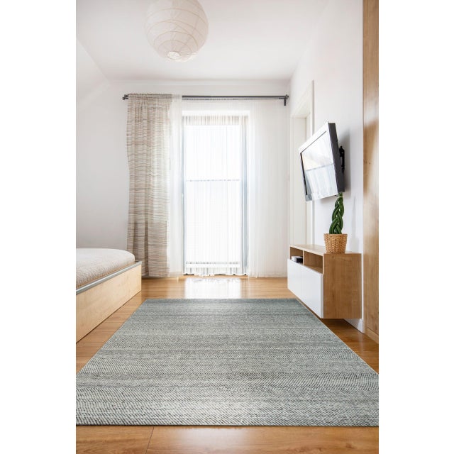 Louie Harlow White Handmade Wool Rug, Country of Origin: India. This striking contemporary piece is defined by its...