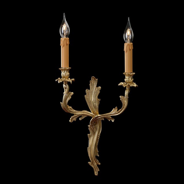 Handcrafted in Italy, this elegant two-light wall sconce is cast in solid brass with a radiant French Gold finish....