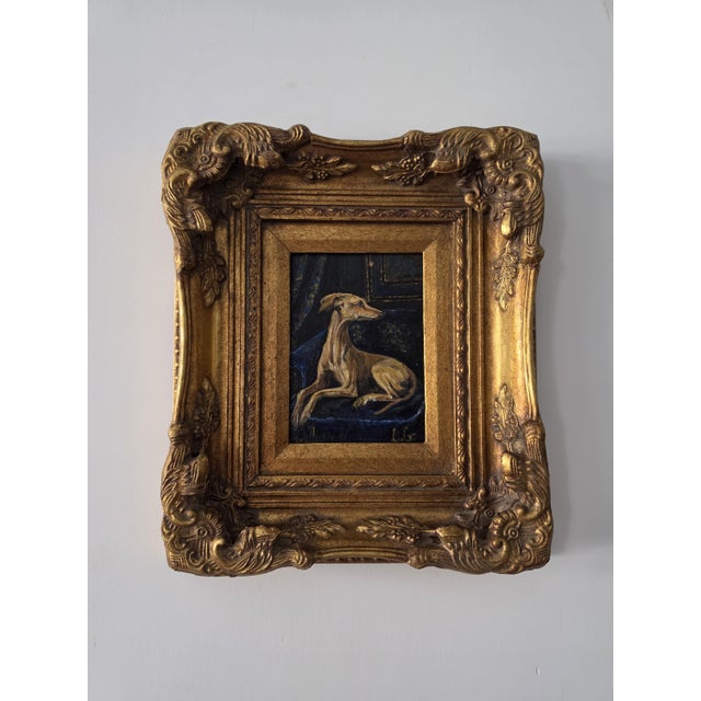 A striking one-of-a-kind oil painting depicting an elegant greyhound or whippet reclining against a dramatic dark...