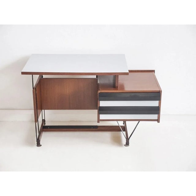 Small writing desk of wood and metal, Formica tabletop. Front of the two drawers painted in black and white. Made in Italy...
