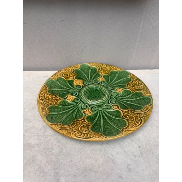 Colorful French Majolica green and yellow oyster plate with stylized leaves, circa 1890.