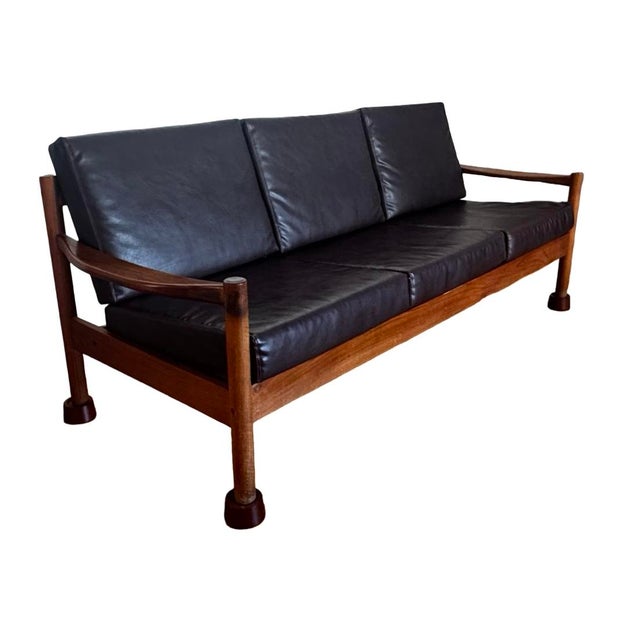 This beautifully proportioned piece showcases the clean architectural lines and refined craftsmanship that define mid-...