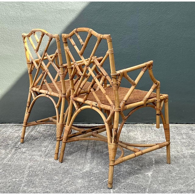 Elevate your dining space with this exceptional set of four vintage Chinese Chippendale style rattan armchairs. Expertly...