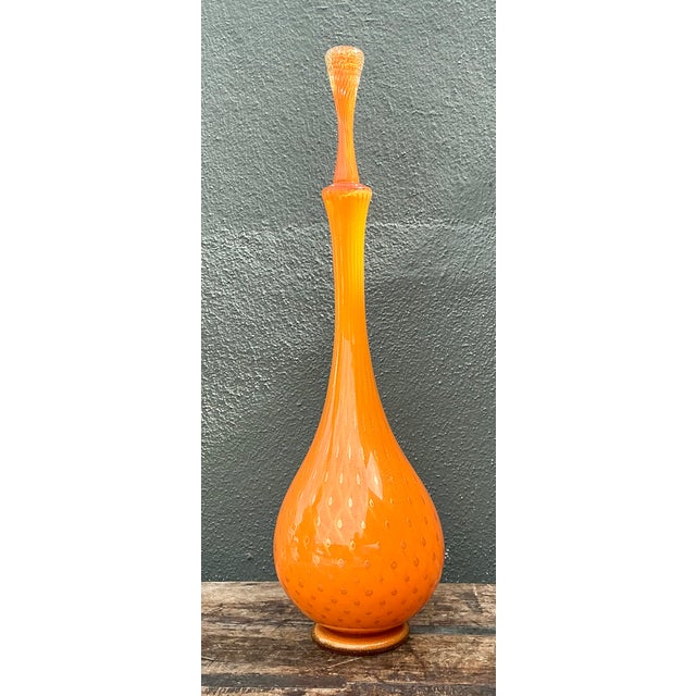 This vintage Murano glass decanter showcases the sculptural elegance of mid-century Venetian design. Tall and richly...