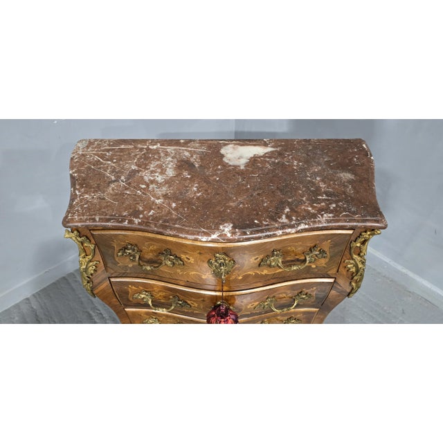 A wonderful small size French bombe shaped commode chest of three drawers, marquetry panels to the sides and drawers...