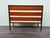 An elegant vintage three-drawer chest of drawers, crafted from teak veneer with white lacquered Formica front details. The...