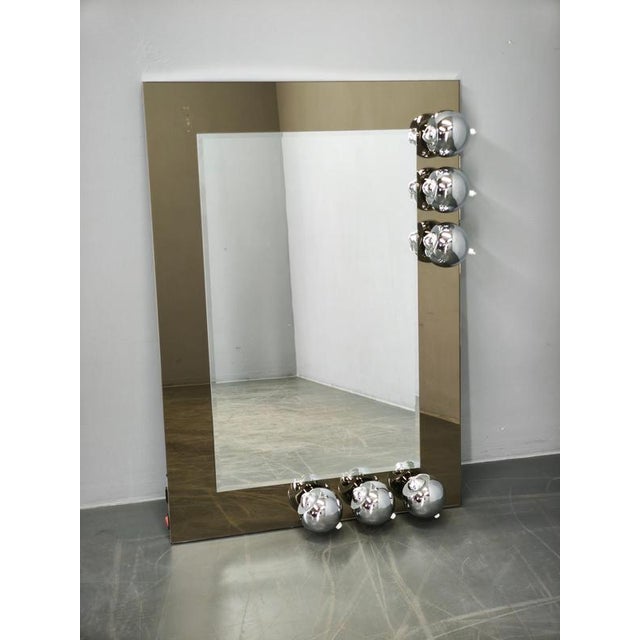 Exceptional large illuminated Space Age mirror with six adjustable chrome eyeball lights, made in Italy during the 1970s....