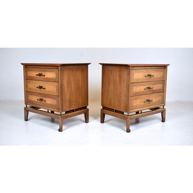 A pair of high-quality Mid 20th century Modern nightstands by White Furniture of Mebane, expertly crafted of walnut burled...