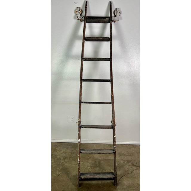 A wonderfully sculptural 19th century wooden ladder featuring its original timeworn painted surface and beautifully aged...
