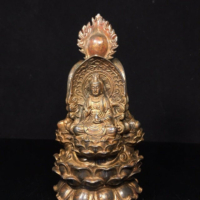 This is a finely crafted antique gilt bronze sculpture depicting the Saha Trinity (also known as the Three-Faced Buddha),...