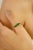 Elegant and timeless, this five-stone band ring features a total of 0.89 carats of vibrant square-cut emeralds,...