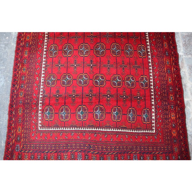 This Belouch Hand knotted Afghan taimani wool rug with its Geometric pattern is a beautiful addition to any home. The...