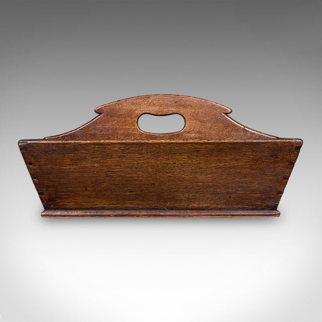 This is an antique maid's carry. An English, oak country house silver polishing box or butler's cutlery tray, dating to...