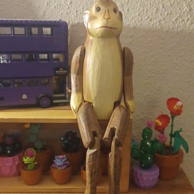 Hand Carved wooden monkey, all joints are good. it's 15 inches tall and can sit on any shelf. he is very cute