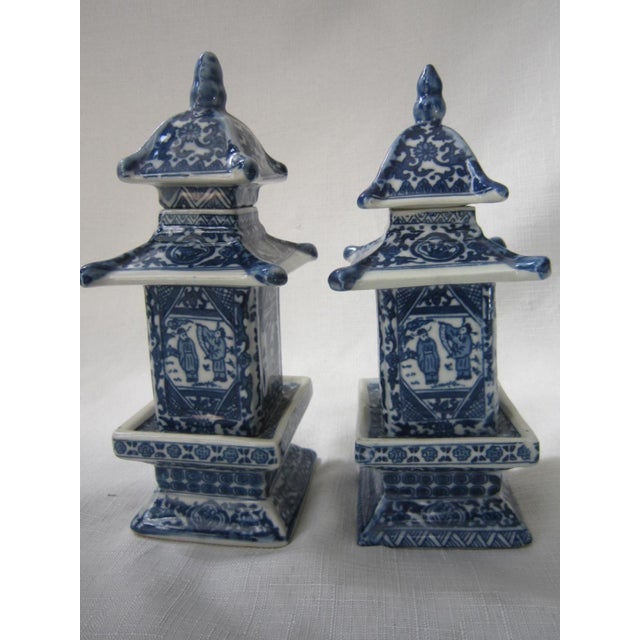 Charming Pair of Blue and White Chinese Pagoda Jars. Each measures 8"H x 3"W x 3"D and has makers marks on the base. Both...