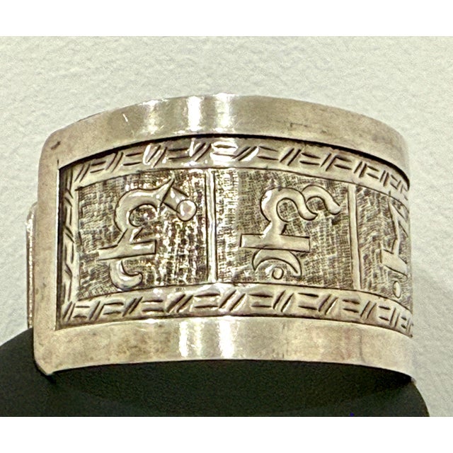 Just over 1.25” wide sterling silver Tibetan Om Mani cuff. 8” adjustable. Weighs 40 grams. Stamped 925.
