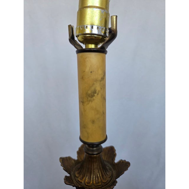 Description This richly detailed brass table lamp brings Old World elegance to any interior, offering a sculptural...