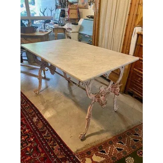 A rare late 19th century French butcher table — cast iron base with a double bull's head and original marble top. Measures...