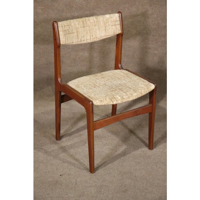 Set of four dining chairs with soft teak frames and upholstered seat and back. Danish made Mid-Century Modern design.