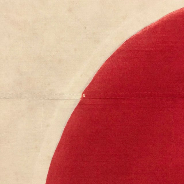 This vintage Japanese flag is made from a cotton or similar cloth, with imperfect hand-painted emblem. Please note overall...