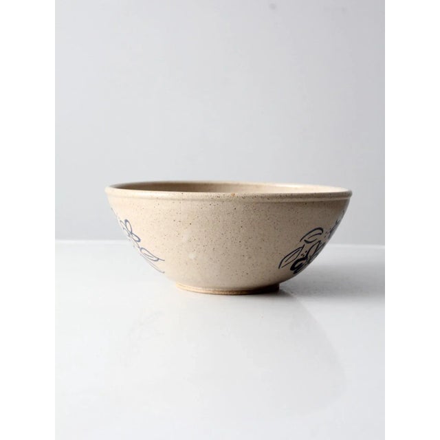 This a vintage Alan Jones studio pottery bowl dated 1991. hand-thrown ceramic with a warm tan speckled glaze, accented by...