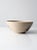 This a vintage Alan Jones studio pottery bowl dated 1991. hand-thrown ceramic with a warm tan speckled glaze, accented by...