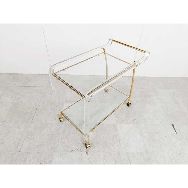Elegant vintage brass and acrylic glass serving trolley with clear glass tops. 1970s - France Very good condition...